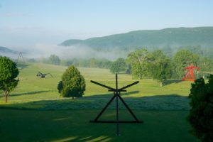 foggy field with several works of large-scale sculpture