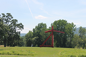 Artwork Mother Peace by Mark di Suvero in a green field on a sunny day.