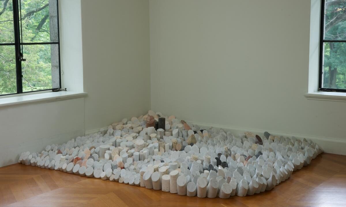 1,200 cylindrical pieces of marble and travertine of various heights sit close to the floor.